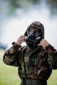 Senior Airman Ronaldo Perez, from the 628th Comptroller Squadron, dons a gas mask during a chemical, biological, radiological, nuclear and explosives drill as part of Exercise Crescent Reach 16, May 19, 2016, at Joint Base Charleston, S.C. The exercise tested JB Charleston’s ability to launch a large aircraft formation and mobilize a large amount of cargo and passengers. (U.S. Air Force photo/Staff Sgt. Jared Trimarchi)