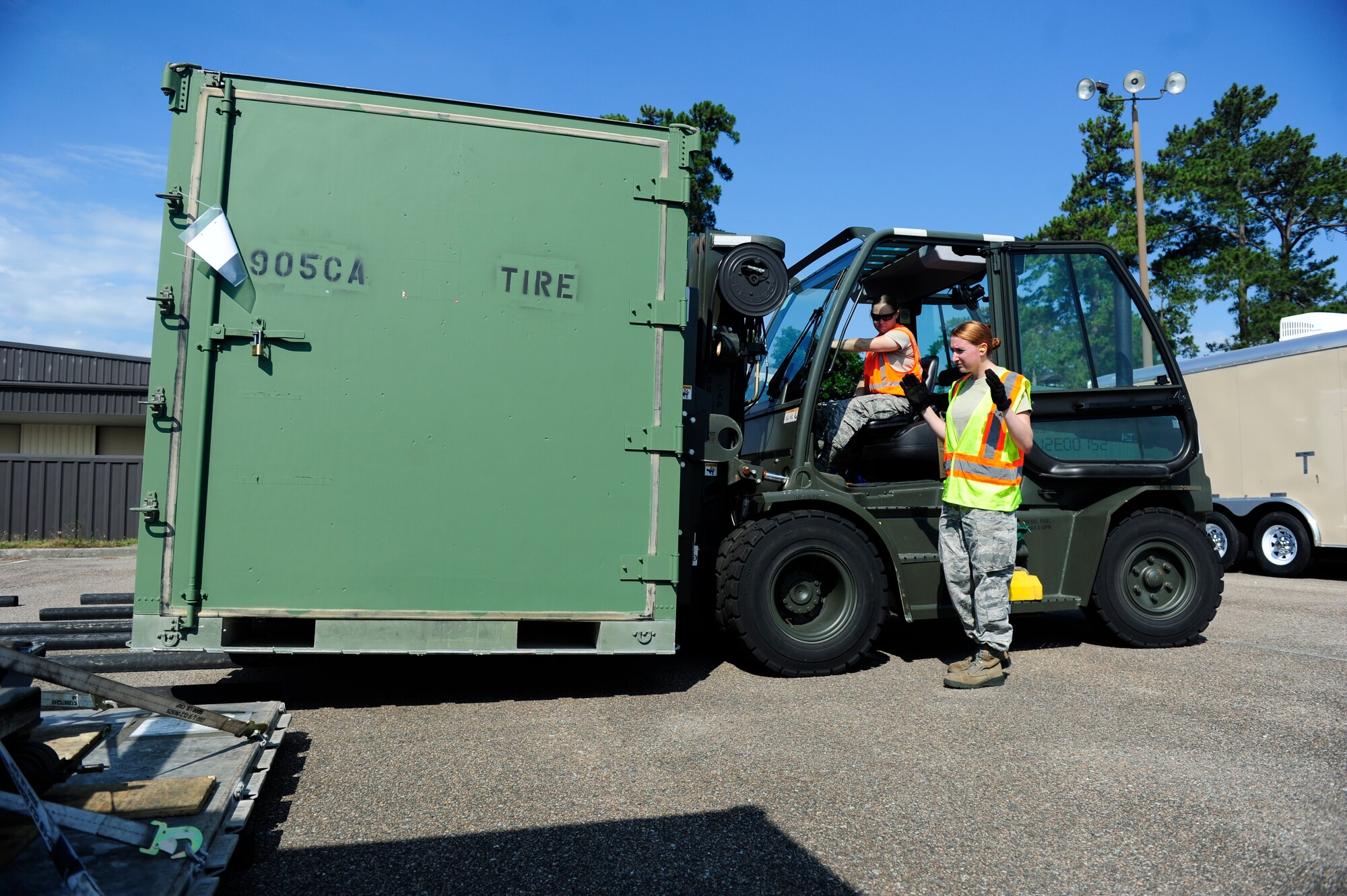 Senior Airman Brandilyn Grant, from the 437th Aerial Port Squadron (right), guides Airman 1st Class Sarah White in forklift operations during a mobility exercise May 24, 2016, at Joint Base Charleston, S.C. The mobility portion is part of a larger exercise, Crescent Reach 2016, which tests the 437th Airlift Wing’s and the 628th Air Base Wing’s ability to deploy passengers and cargo as well as launch a large aircraft formation in response to a worldwide crisis. (U.S. Air Force Photo by Airman 1st Class Kevin J. West)