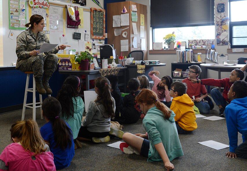 Capt. Laura Quaco, 62nd Airlift Wing chief of legal assistance and preventative law, helps the kids from Carter Lake Elementary School, Joint Base Lewis-McChord, Wash., with judicial system terminology during the nation-wide Law Day activities May 25, 2016. Members of the 62nd Airlift Wing Legal office volunteered to help the students get a better understanding of legal processes. (U.S. Air Force photo/Senior Airman Divine Cox)