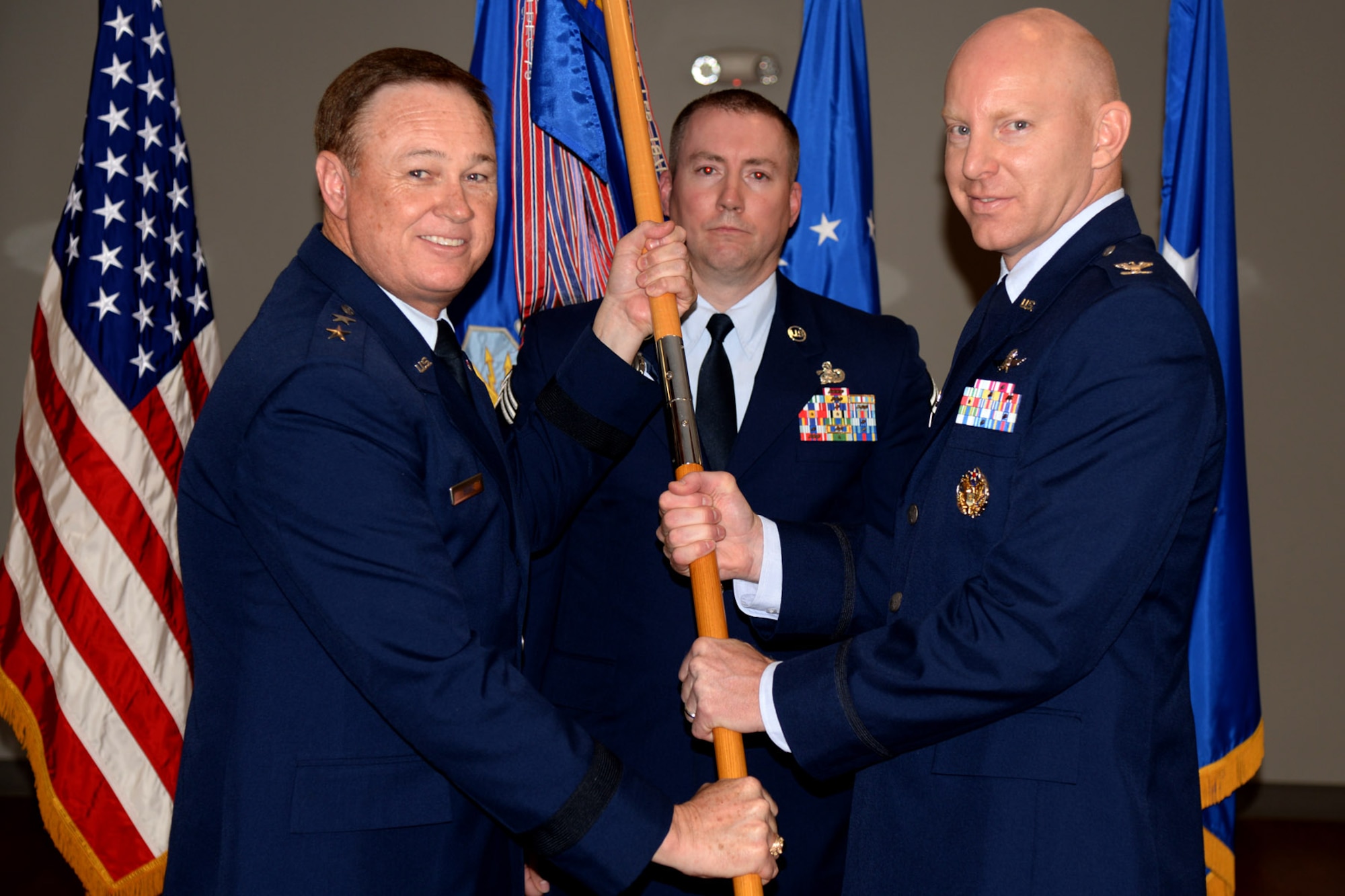 Col. Bradley Barnhart relinquishes command of the 844th Communications Group during a change-of-command ceremony presided by Air Force District of Washington Commander Maj. Gen. Darryl Burke on Joint Base Andrews, Md., May 26, 2016. The 844th Communications Group provides communications and information support to Air Force National Capitol Region warfighters, including Headquarters Air Force District of Washington, the 11th Wing , 79th Medical Wing and various other organizations throughout the NCR. (U.S. Air Force photo/Tech. Sgt. Matt Davis)