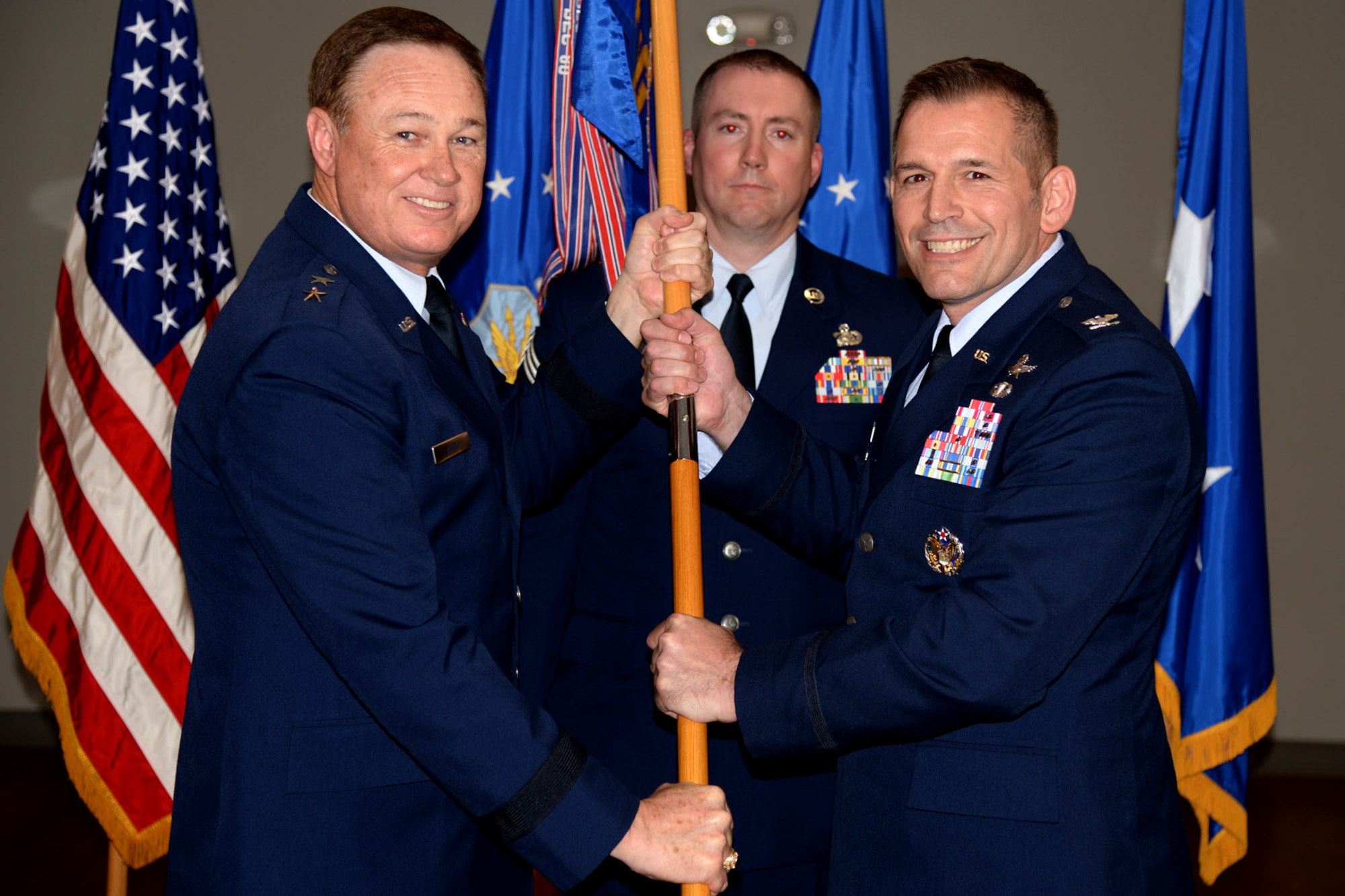 Col. Rocky Favorito accepts command of the 844th Communications Group during a change-of-command ceremony presided by Air Force District of Washington Commander Maj. Gen. Darryl Burke on Joint Base Andrews, Md., May 26, 2016. The 844th Communications Group provides communications and information support to Air Force National Capitol Region warfighters, including Headquarters Air Force District of Washington, the 11th Wing , 79th Medical Wing and various other organizations throughout the NCR. (U.S. Air Force photo/Tech. Sgt. Matt Davis)