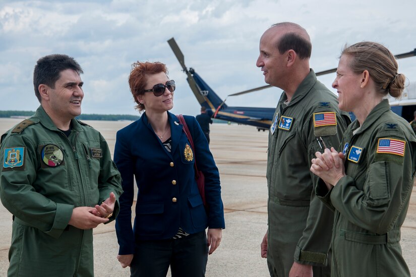 Maj. Gen. Laurian Anastasof, Romanian Air Force chief of air staff (left), and his wife, Karmen Anastasof (center left), talk with Col. Fred Koegler, 811th Operations Group commander (center right), and Col. Julie Grundahl, Joint Base Andrews and 11th Wing vice commander (right), during his visit to JBA, Md., May 23, 2016. Gen. Anastasof visited the base as part of the U.S. Air Force’s Counterpart Visit Program. (U.S. Air Force photo by Airman Gabrielle Spalding)