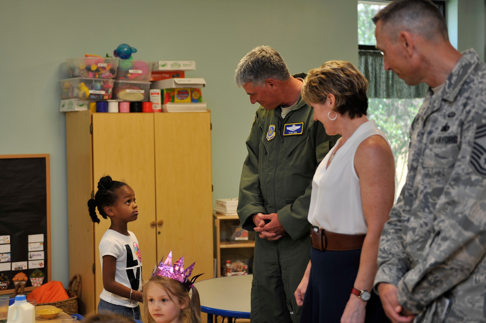 U.S. Air Force Lt. Gen. Sam Cox, 18th Air Force commander, along with his spouse Tammy and U.S. Air Force Chief Master Sgt. Todd Petzel, 18th Air Force command chief, visit with children at the Child Development Center May 23, 2016, on Little Rock Air Force Base, Ark. The CDC takes care of more than 170 children up until 5 years of age for services members and civilians who work on Little Rock Air Force Base. (U.S. Air Force photo by Senior Airman Stephanie Serrano)