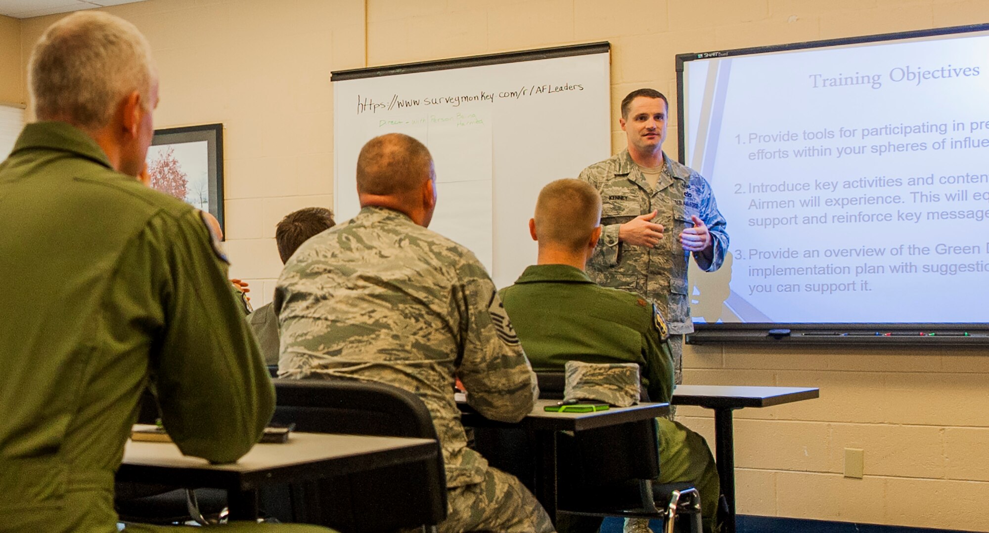Tech. Sgt. Mark Kenney, a Green Dot implementer, provides training to base leadership May 9 at Eglin Air Force Base, Fla. The Green Dot program will be used to train Airmen here and across the Air Force to help reduce power-based interpersonal violence. The idea behind GD is that the small proactive actions of intervention by bystanders will influence the behavior of others to create a ‘new normal’ within their social groups and communities impacting cultural change, teaching that violence and inaction are unacceptable. GD training began recently and is mandatory for all base personnel. (U.S. Air Force photo/Ilka Cole)  
