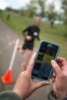 A runner crosses the finish line April 28 during the Hill Air Force Base Spring Race Series’ fourth race on the ‘Log Cabin’ course. (U.S. Air Force photo by Paul Holcomb)