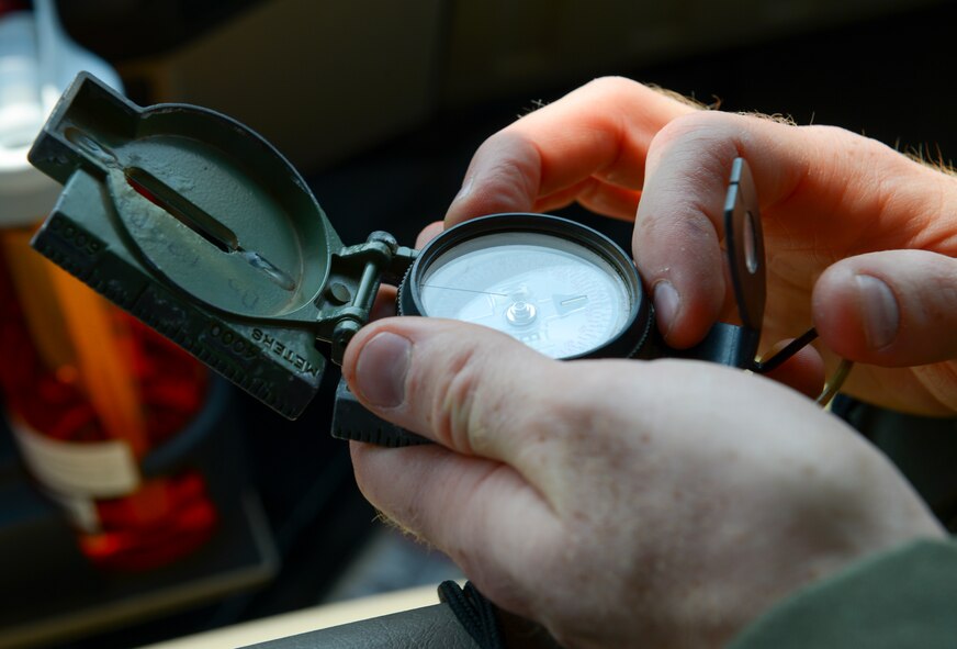 2nd Lt. Bobby Thomas Jr., 36th Airlift Squadron C-130 Hercules navigator, uses a compass to determine wind direction at Yokota Air Base, Japan, May 23, 2016. While coordinating the drop zone for a personnel drop, Thomas is responsible for communicating the information gathered to the aircraft commander, ensuring the jumpers leave the aircraft at the best point and land on target.  (U.S. Air Force photo by Airman 1st Class Elizabeth Baker/Released)