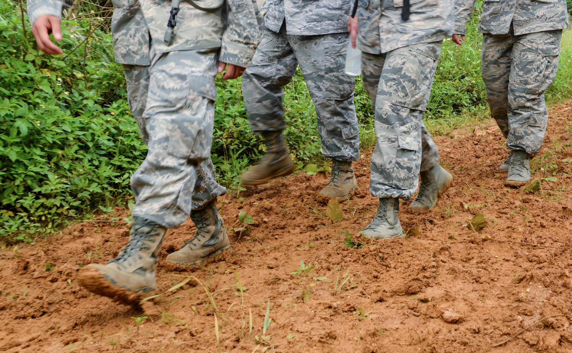 Airmen from the 18th Medical Group make their way toward a field training site, May 20, 2016, at Area One, Kadena Air Base, Japan. More than 50 personnel participated in the Preventative Aerospace Medicine Convention a field training day focused on establishing and supporting an operational site in a deployment environment.  (U.S. Air Force photo by Senior Airman John Linzmeier)