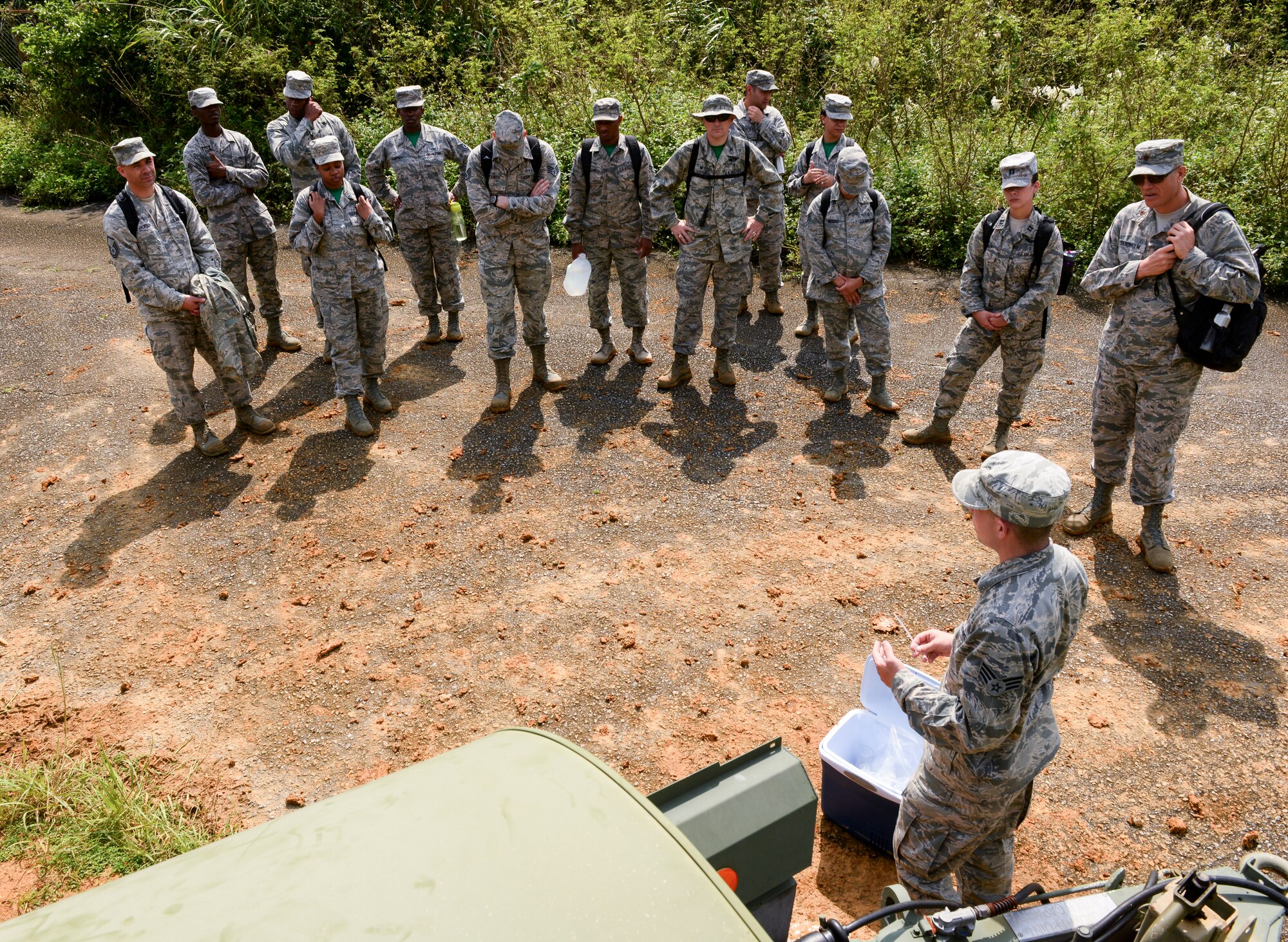 Airmen from the 18th Medical Group gather around a water buffalo and learn how to take a water sampling during a field training day May 20, 2016, at Area One, at Kadena Air Base, Japan. The first-of its kind training, known as the Preventative Aerospace Medicine Convention, or PAMACON, included site selection and coordination with civil engineering to determine where to place dining facilities, latrines and other necessary amenities in order to establish an operating environment. (U.S. Air Force photo by Senior Airman John Linzmeier) 