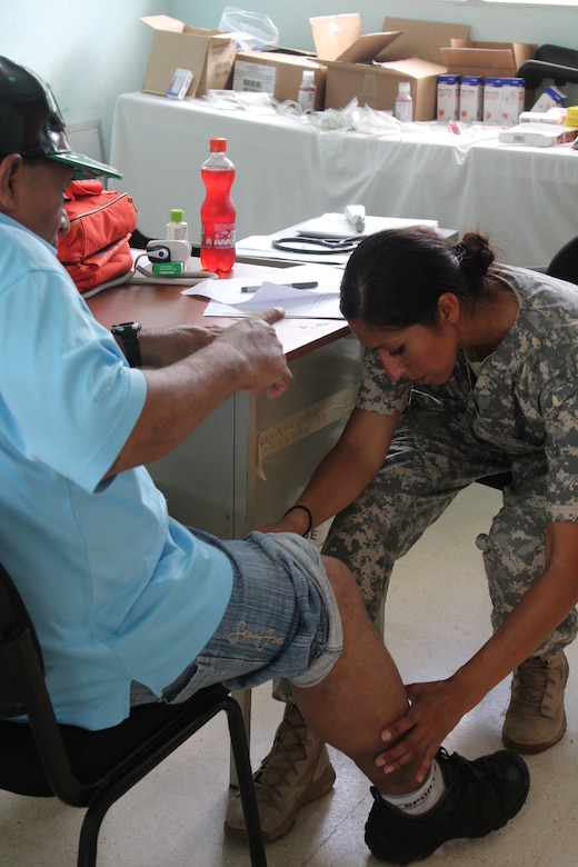 U.S. Army Sgt. 1st Class Veronica Badillo, Joint Task Force-Bravo Medical Element, examines a Nicaraguan man’s leg during a consultation, while participating in a Medical Readiness Training Exercise, May 18, 2016, in Alamikamba, Nicaragua. MEDRETEs help validate service members’ ability to provide care under austere conditions in remote locations, such as the Nicaraguan Miskito Coast, while providing an opportunity to help the host nation and build relationships between the U.S. and the Central American countries. A total of 1,265 Nicaraguans received care during the MEDRETE, which included participation from Nicaraguan Ministry of Health and Army in cooperation with JTF-Bravo service members and Honduran medical liaisons from Soto Cano Air Base, Honduras. (U.S. Army photo by Maria Pinel)