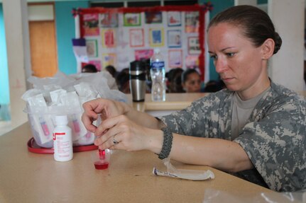U.S. Army SSgt Lisa Kent, Joint Task Force-Bravo Preventive Medicine, fill syringes with deworming medication to provide to the children who visited the Prinzu Pawanka Hospital during a Joint Task Force-Bravo-led Medical Readiness Training Exercise in Alamikamba, Nicaragua, May 19, 2016. After receiving an initial health class, which provided guidance on how to avoid common illnesses, patients were seen by medical providers and received medication for their illnesses free of charge.  A total of 1,265 Nicaraguans received care during the MEDRETE, which included participation from Nicaraguan Ministry of Health and Army in cooperation with JTF-Bravo service members and Honduran medical liaisons from Soto Cano Air Base, Honduras.  (U.S. Army photo by Maria Pinel)

