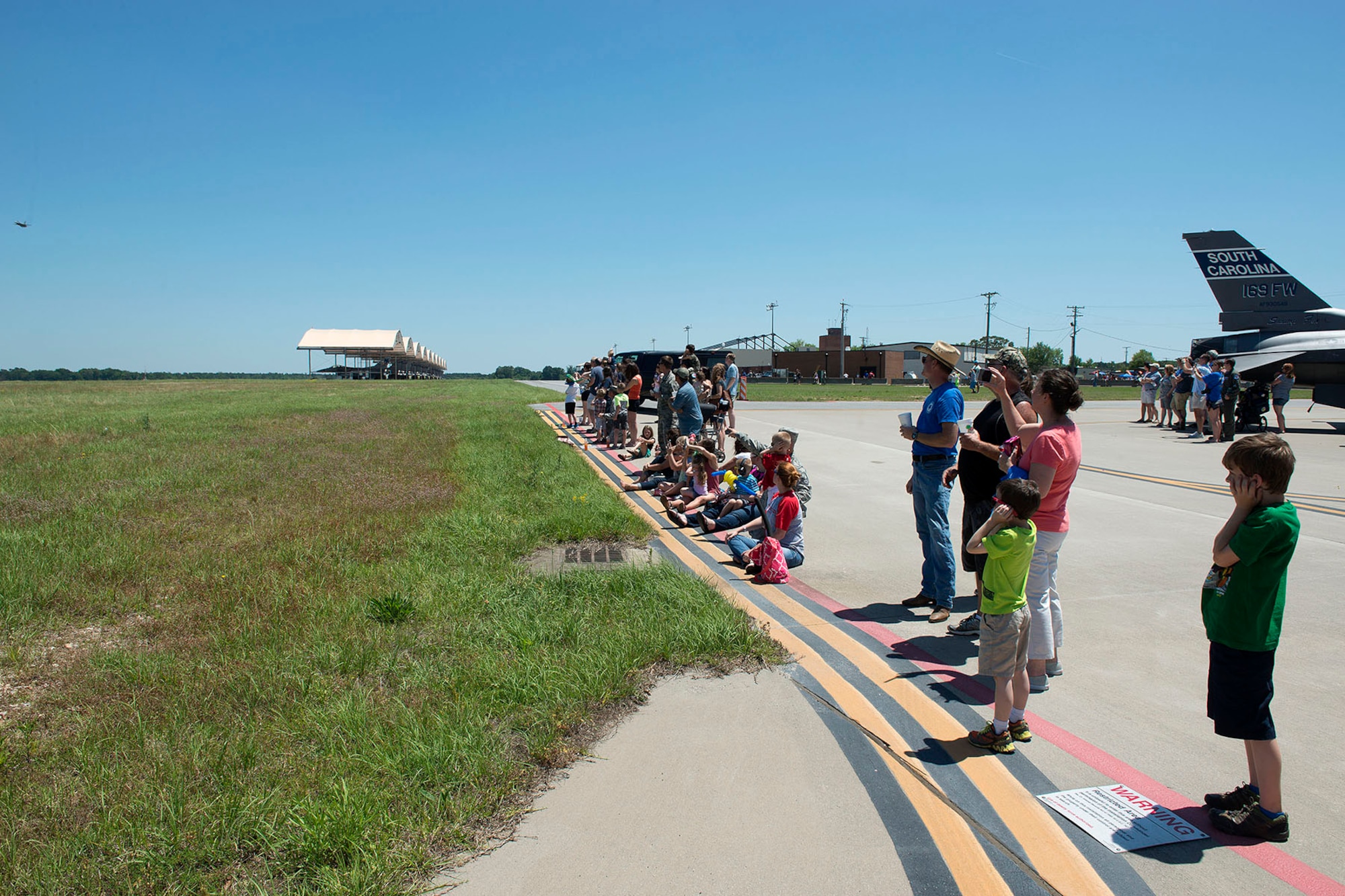 Swamp Fox Airmen and families gather during the 169th Fighter Wing Family Day for fun and fellowship at McEntire Joint National Guard Base, S.C., May 14, 2016. Local businesses and base support programs provided food and event activities to show their appreciation for the continued service of South Carolina Air National Guard and 169th Fighter Wing families and Airmen.  (U.S. Air National Guard photo by Tech. Sgt. Jorge Intriago)