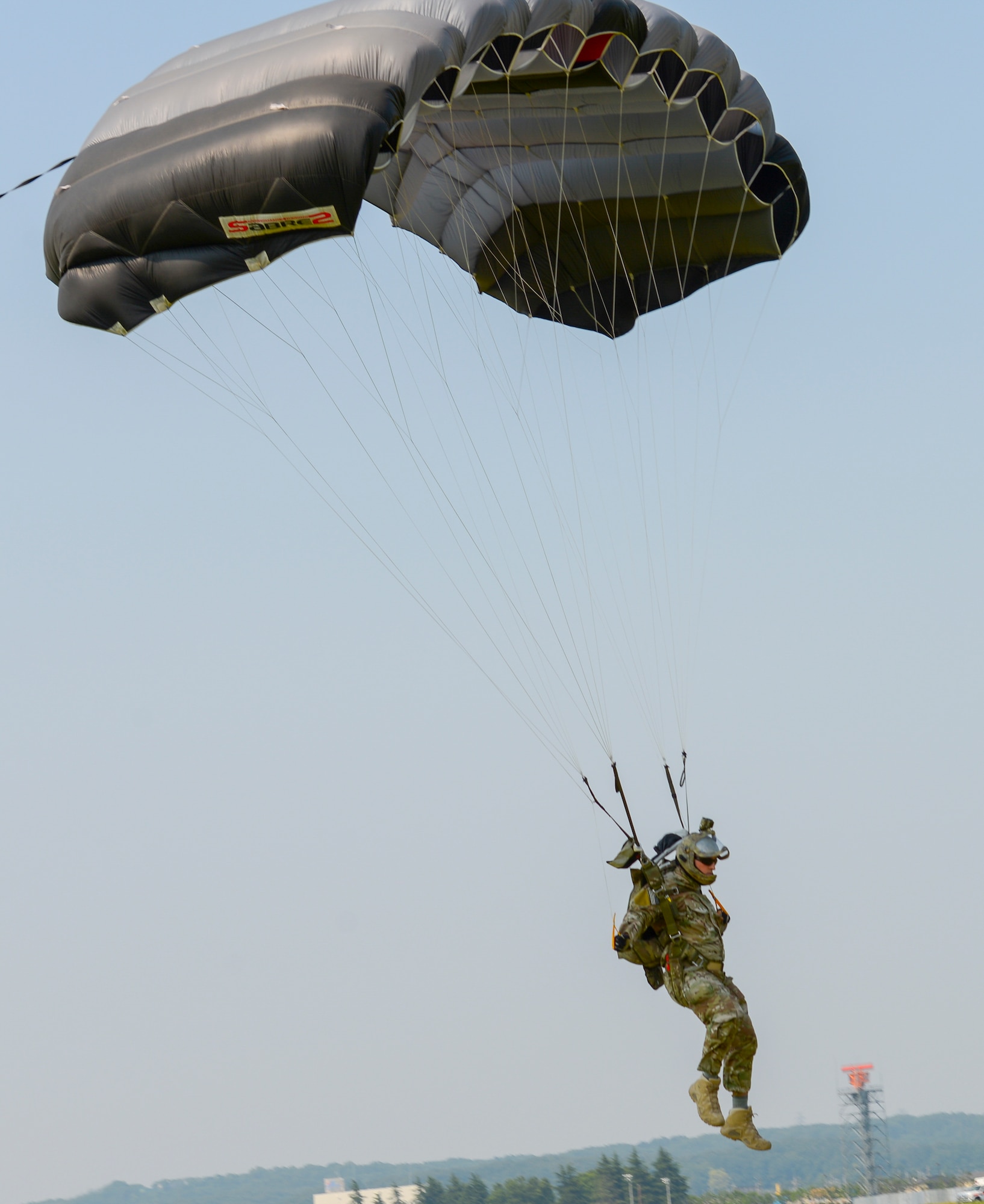 Tech. Sgt. Benjamin Johnis, 374th Operations Squadron NCO in charge of Survival, Evasion, Resistance and Escape operations, parachutes onto the airfield at Yokota Air Base, Japan, May 23, 2016. Members with the 374 OSS SERE conduct regular jump training to stay qualified and achieve proficiency in their skills. (U.S. Air Force photo by Airman 1st Class Elizabeth Baker/Released)