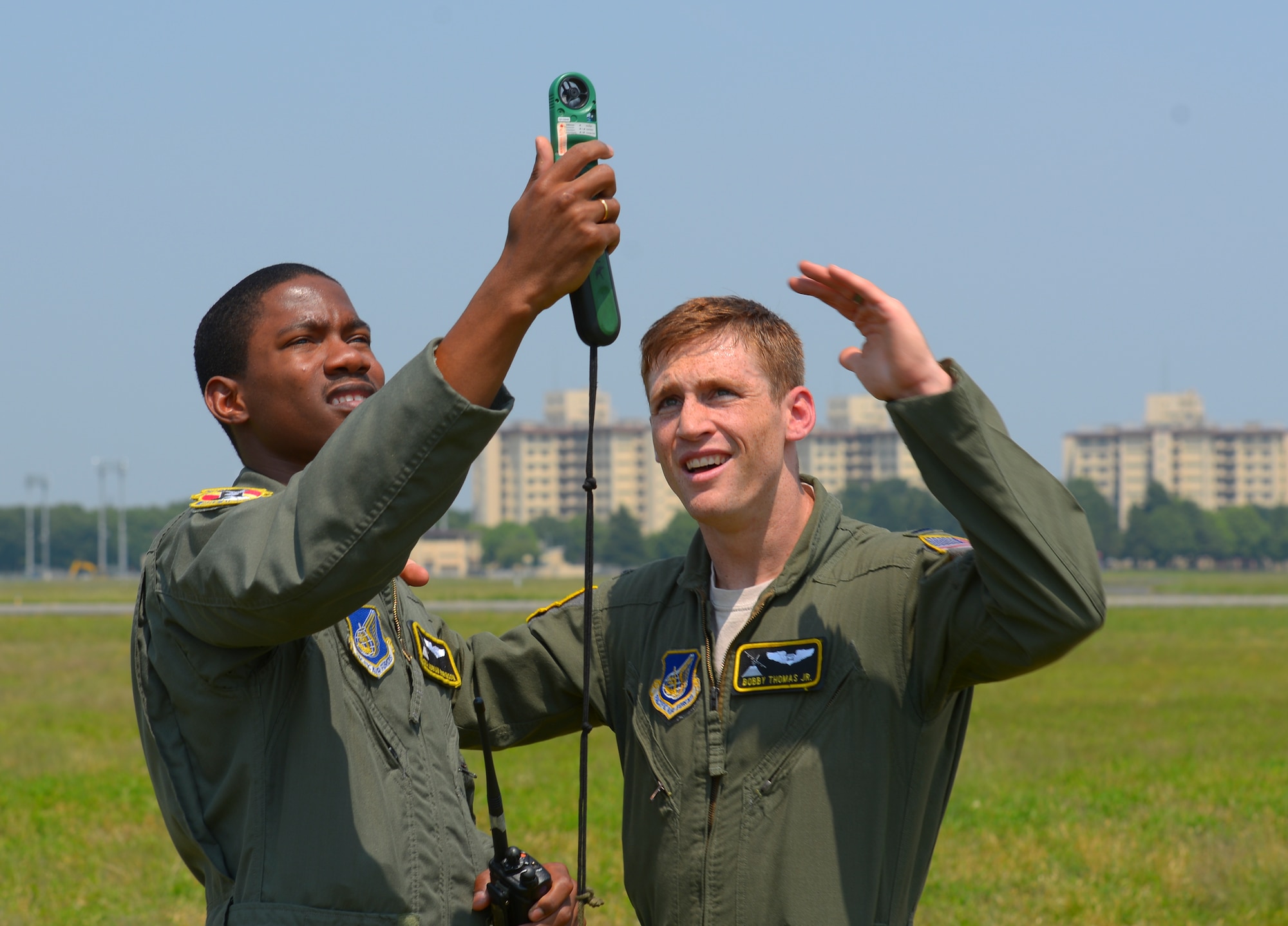 2nd Lt. Bobby Thomas Jr., 36th Airlift Squadron C-130 Hercules navigator, instructs Senior Airman Adrian Robinson, 36 AS C-130H loadmaster, to take wind readings at Yokota Air Base, Japan, May 23, 2016. As a drop zone coordinator, Thomas relays wind readings to aircraft commanders and jump masters to determine if jumpers should be released and where. (U.S. Air Force photo by Airman 1st Class Elizabeth Baker/Released)