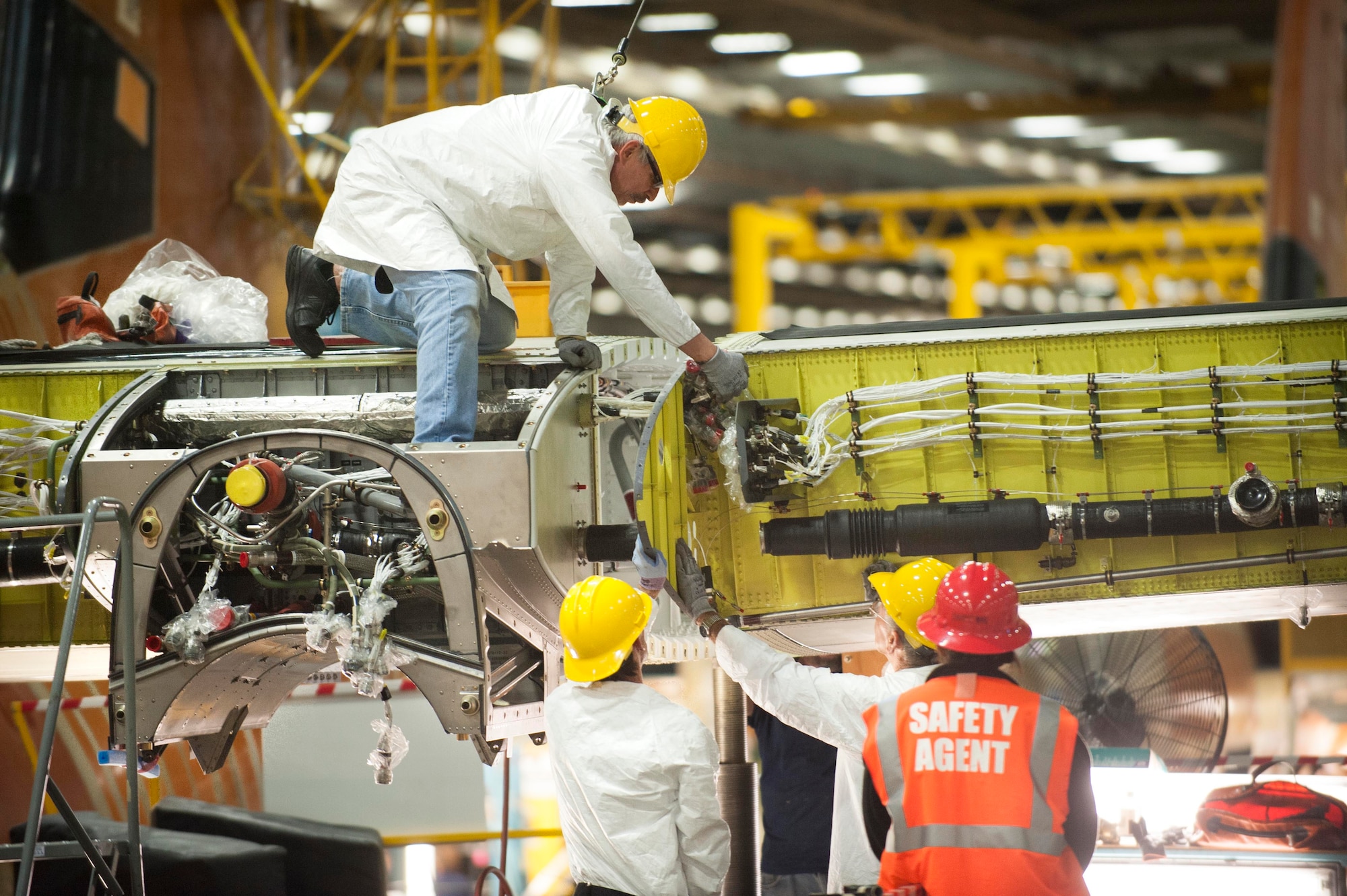 A wing is installed onto a C-130J at the Lockheed Martin Aeronautics facility in Marietta, Georgia. The 374th Airlift Wing at Yokota Air Base, Japan, is scheduled to receive its first C-130J (the aircraft in the photo) by the end of 4th quarter 2016. (Photo by Andrew McMurtrie)