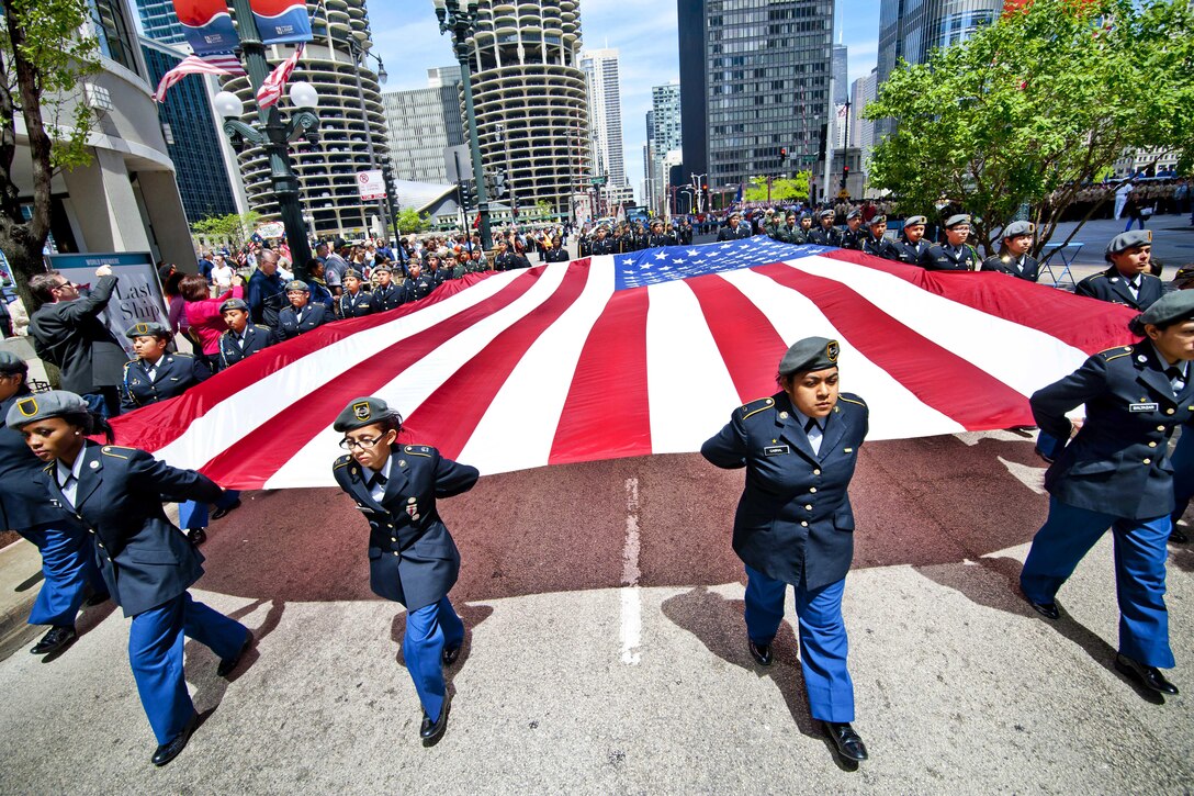 Junior ROTC cadets from a Chicago public school carry an American flag during Chicago's Memorial Day Parade, May 24, 2014. Army photo by Sgt. 1st Class Michel Sauret