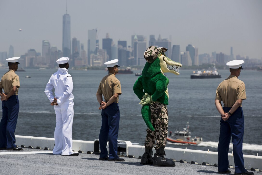 Marines, sailors and a "gator" mascot aboard the USS Bataan man the rails during the parade of ships as part of Fleet Week New York in New York City, May 25, 2016. The Bataan transported more than 500 troops assigned to the 24th Marine Expeditionary Unit to the event. Marine Corps photo by Cpl. Todd F. Michalek
