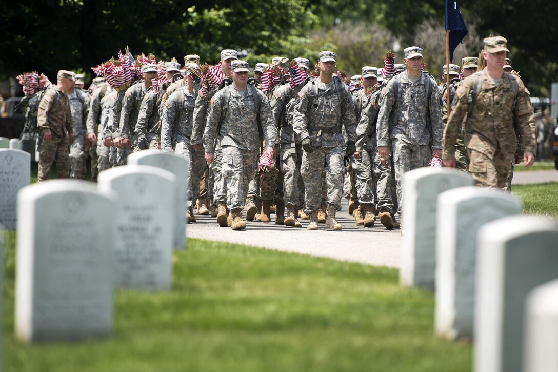 Soldiers march into Arlington National Cemetery from Joint Base Myer-Henderson Hall to participate in "Flags In" at Arlington National Cemetery in Arlington, Va., May 26, 2016. The soldiers are assigned to the 3rd U.S. Infantry Regiment, known as "The Old Guard." Each of the cemetery's approximately 230,000 headstones receives a flag for the Memorial Day holiday. Army photo by Rachel Larue