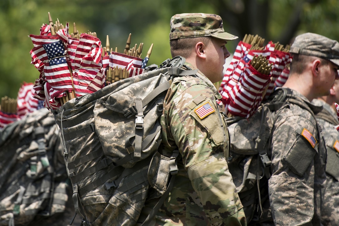 Soldiers carry American flags in backpacks while participating in "Flags In" at Arlington National Cemetery in Arlington, Va., May 26, 2016. Army photo by Rachel Larue