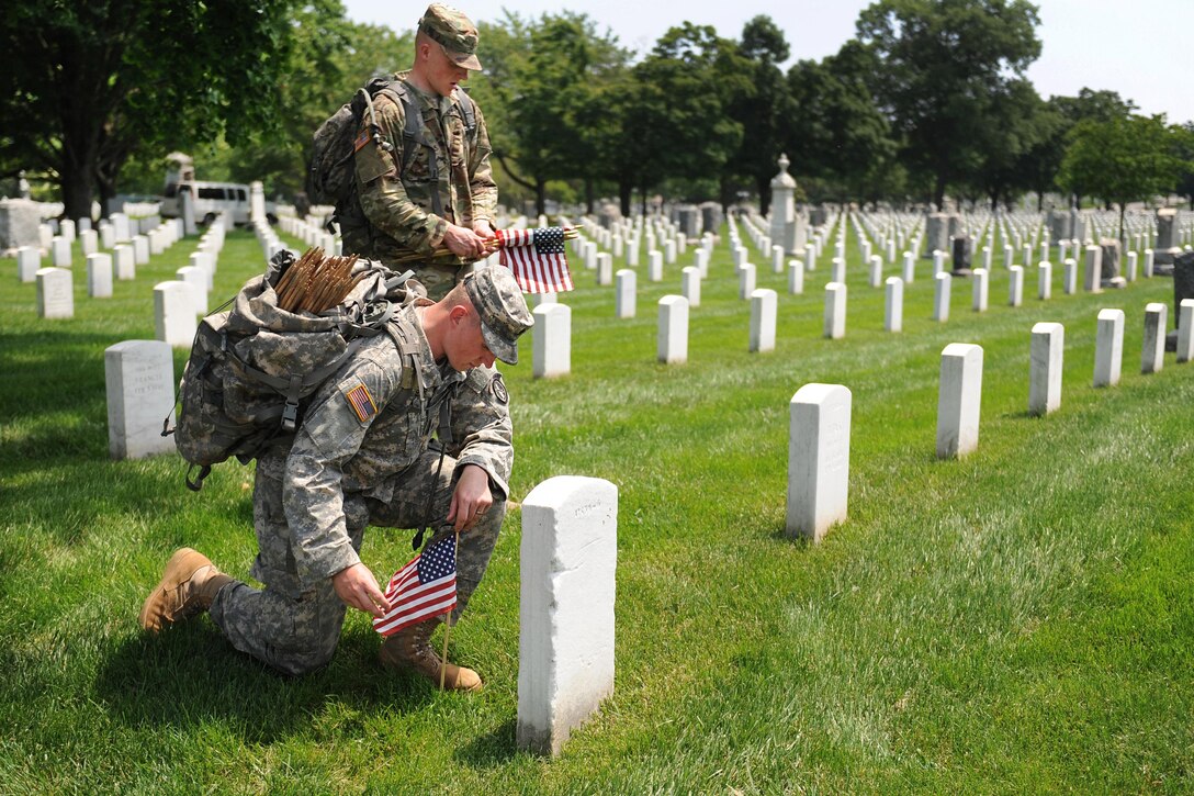 Soldiers pay respects while participating in "Flags In" at Arlington National Cemetery in Arlington, Va., May 26, 2016. DoD photo by Marvin D. Lynchard