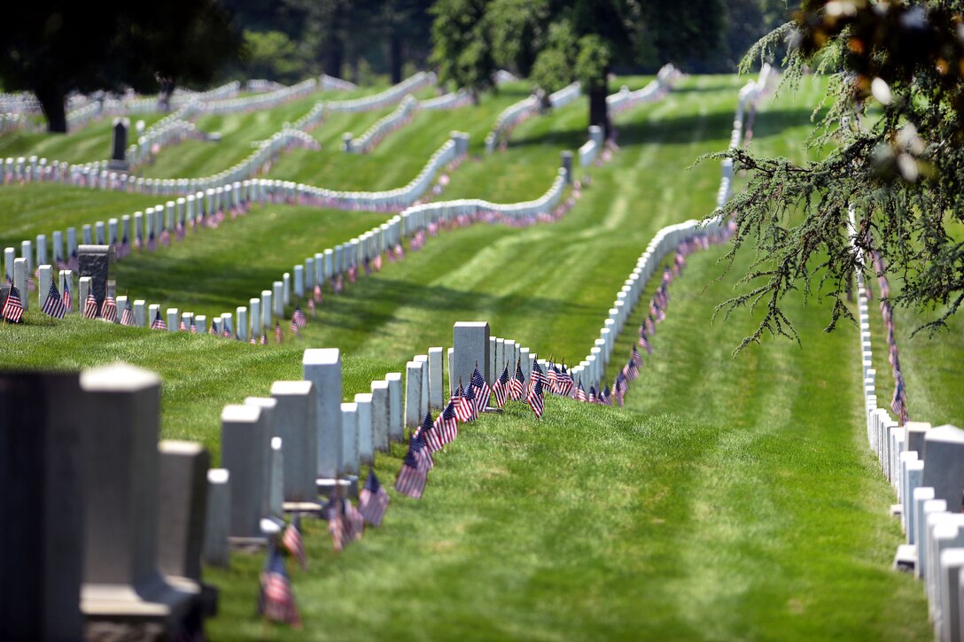 American flags placed by soldiers participating in "Flags In" adorn the headstones at Arlington National Cemetery in Arlington, Va., May 26, 2016. DoD photo by Marvin D. Lynchard