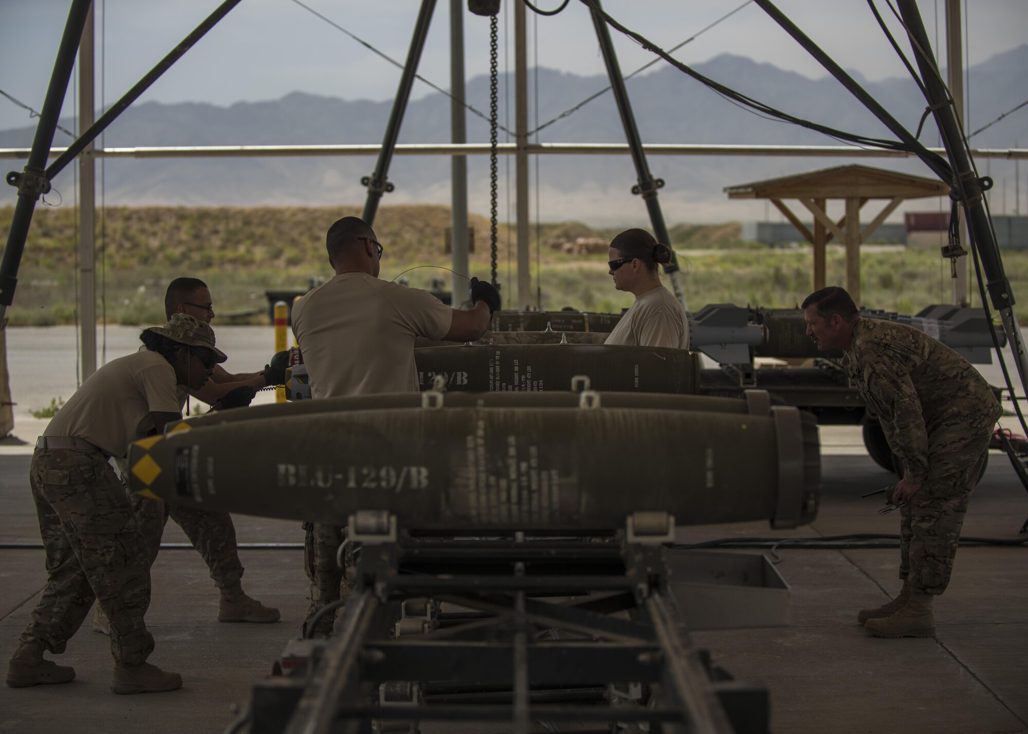 Airmen from the 455th Expeditionary Maintenance Squadron, munitions flight build guided bomb unit (GBU)-54 munitions at Bagram Airfield, Afghanistan, May 26, 2016. The ammo shop plays a key role in ensuring munitions are properly assembled and inspected before they are delivered to the flightline or stockpiled. (U.S. Air Force photo by Senior Airman Justyn M. Freeman)