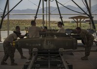 Airmen from the 455th Expeditionary Maintenance Squadron, munitions flight build guided bomb unit (GBU)-54 munitions at Bagram Airfield, Afghanistan, May 26, 2016. The ammo shop plays a key role in ensuring munitions are properly assembled and inspected before they are delivered to the flightline or stockpiled. (U.S. Air Force photo by Senior Airman Justyn M. Freeman)