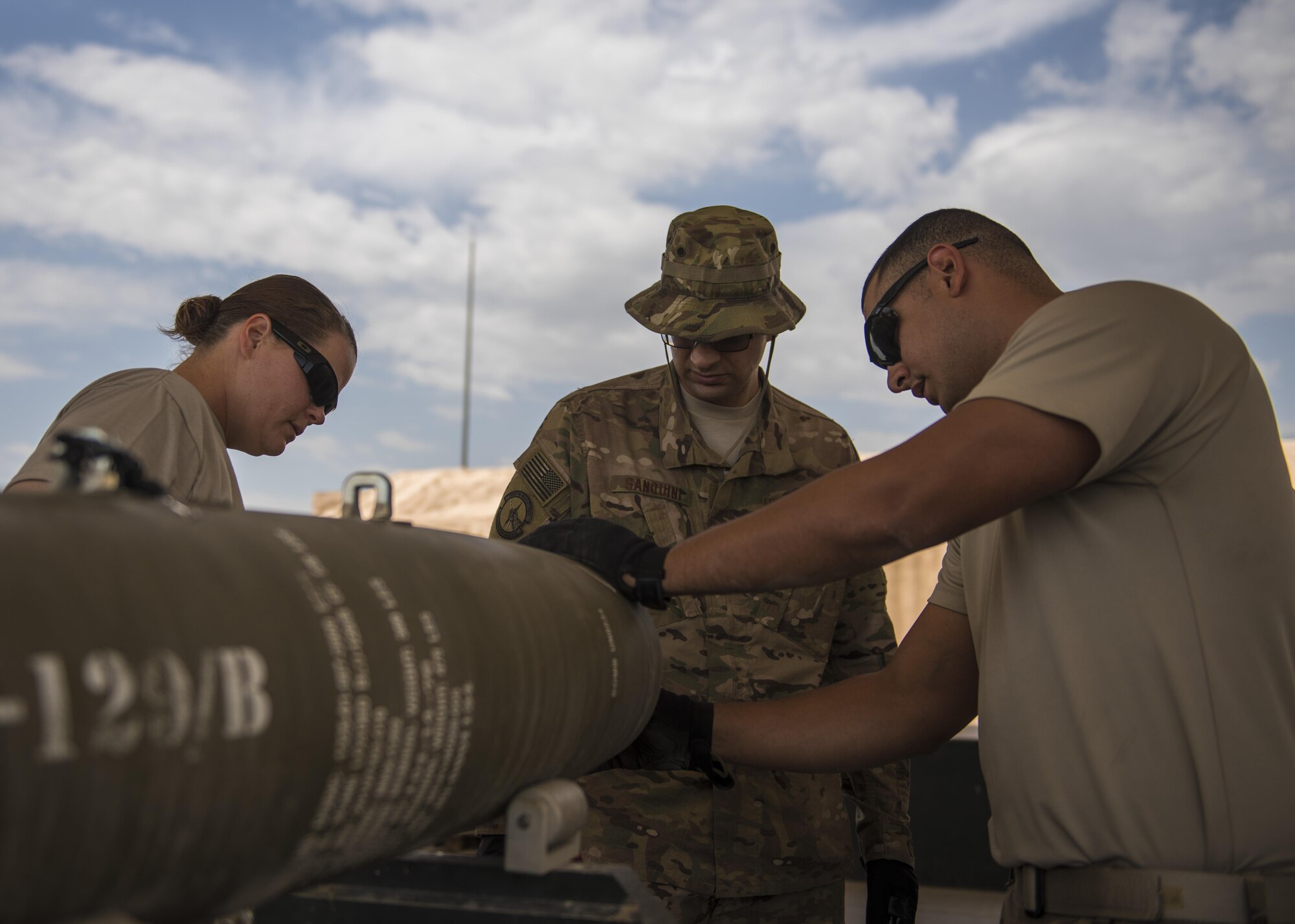 Airmen from the 455th Expeditionary Maintenance Squadron, munitions flight attach the fin portion of a GBU-54 munition at Bagram Airfield, Afghanistan, May 26, 2016. The ammo shop plays a key role in ensuring munitions are built and inspected before they are loaded on trailers and delivered to the flightline or stockpiled. (U.S. Air Force photo by Senior Airman Justyn M. Freeman)