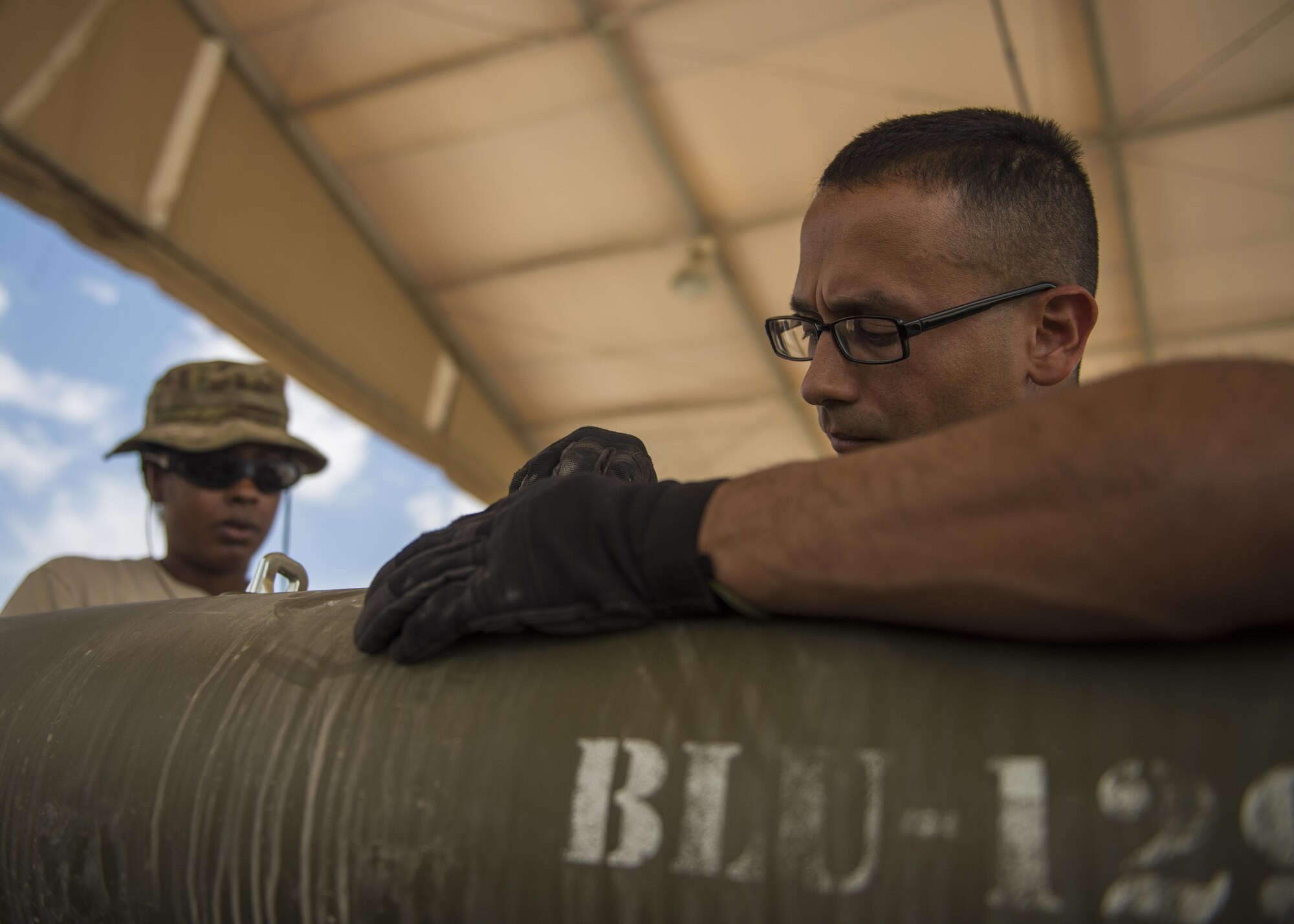 Staff Sgt. Alejandro Medina, 455th Expeditionary Maintenance Squadron Munitions Flight, munitions system specialist, helps build a GBU-54 munition at Bagram Airfield, Afghanistan, May 26, 2016. The munitions flight is responsible for the accountability of small arms ammunitions to large-scale guided bomb units. (U.S. Air Force photo by Senior Airman Justyn M. Freeman)