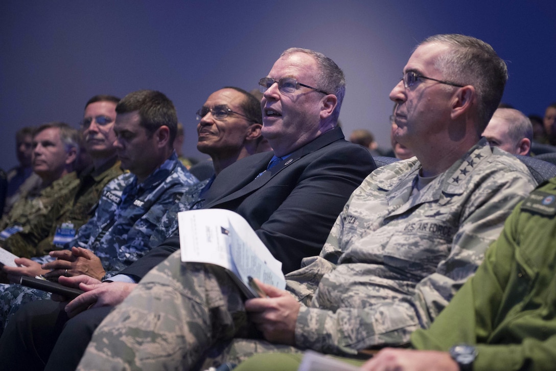 Deputy Defense Secretary Bob Work, second from right, and Air Force Gen. John E. Hyten, right, receive a briefing on Schriever Wargame 2016 at Maxwell Air Force Base, Ala., May 26, 2016. Hyten is commander of Air Force Space Command. DoD photo by Navy Petty Officer 1st Class Tim D. Godbee