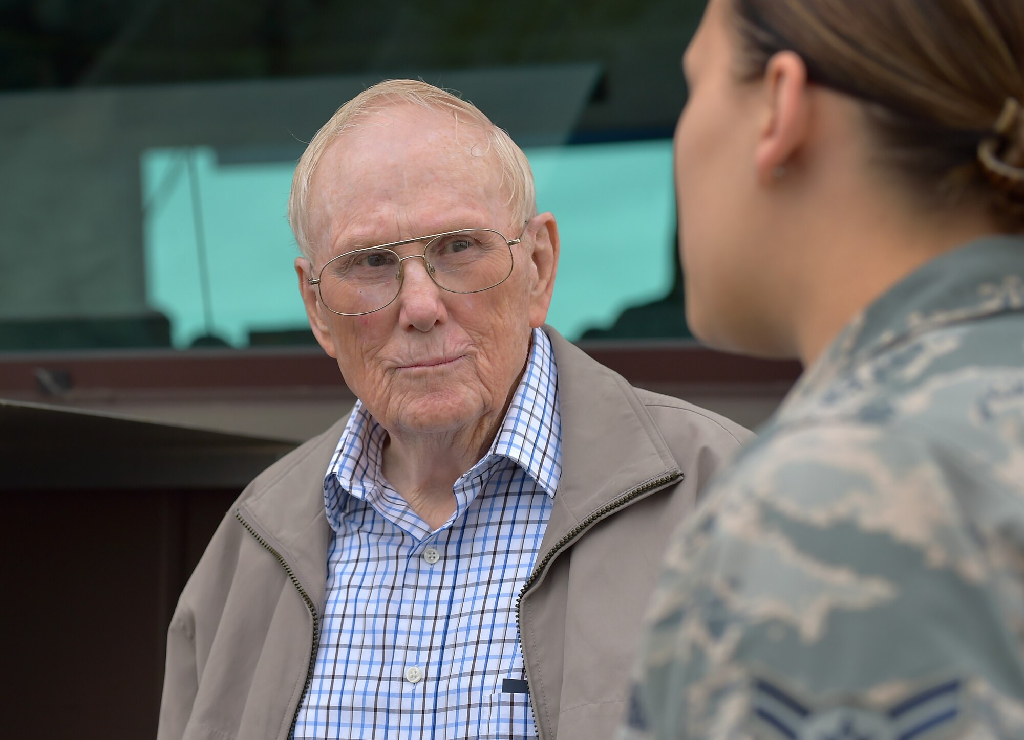 U.S. Air Force Chief Master Sgt. (Retired) Kenneth Andrews speaks with Airman 1st Class Paige Goulette, Air Traffic Control Apprentice, during a visit to Ramstein’s Air Traffic Control tower, May 24, 2016, Ramstein Air Base, Germany. Andrews, who served in several combat roles during his Air Force tenure, hadn’t visited the Ramstein tower since 1962 when he used to work as a traffic controller. 