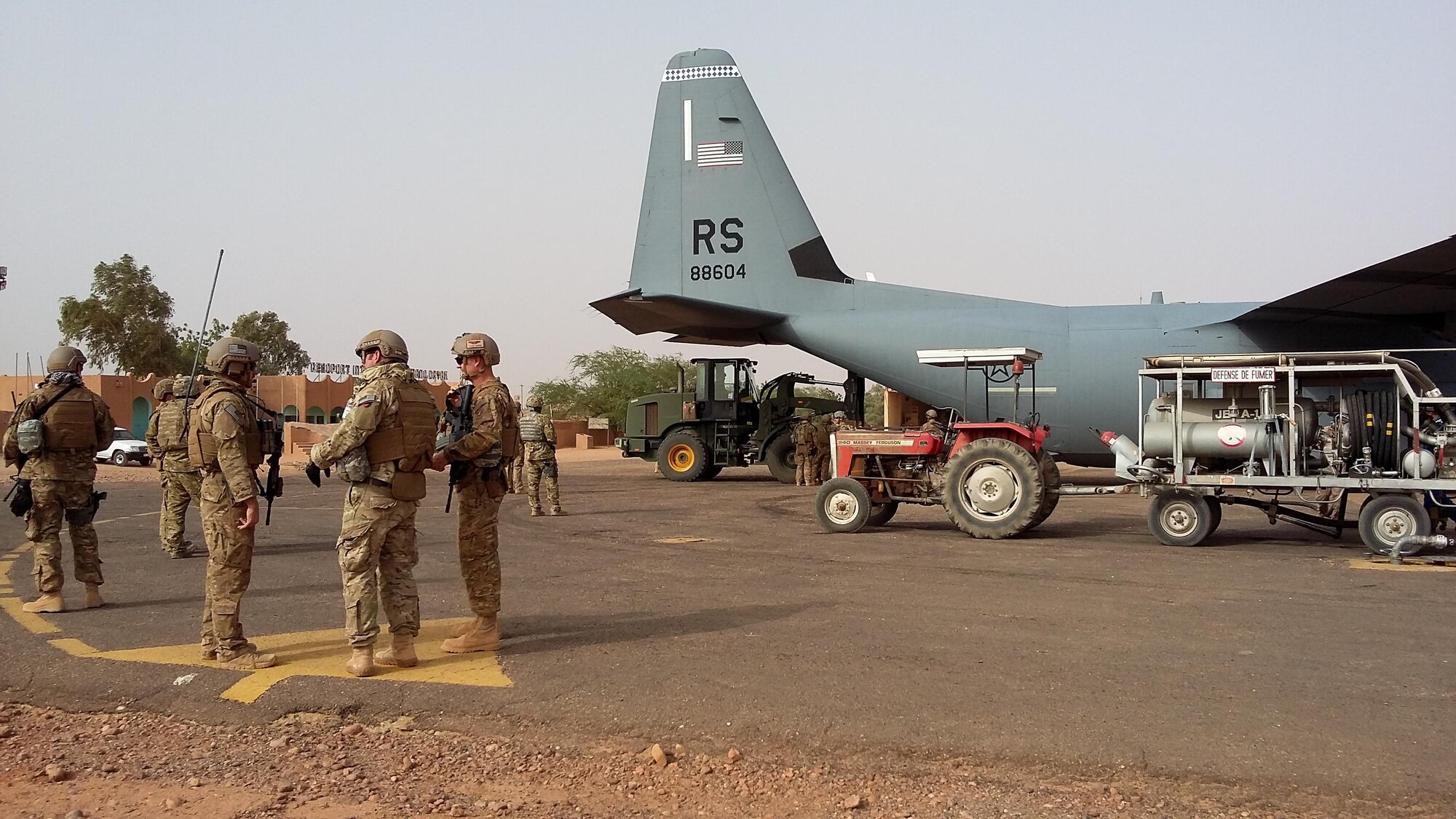Airmen unload a C-130J Super Hercules during a deployment at Agadez, Niger, April 29, 2016.  The 435th Contingency Response Group prepared a strip a land for future-forces to establish a variety of missions. The mission and location added new challenges with 110 degrees Fahrenheit summer heat and the potential of hostile fire. (U.S. Air Force photo/ Jeffrey McGovern)