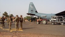 Airmen unload a C-130J Super Hercules during a deployment at Agadez, Niger, April 29, 2016.  The 435th Contingency Response Group prepared a strip a land for future-forces to establish a variety of missions. The mission and location added new challenges with 110 degrees Fahrenheit summer heat and the potential of hostile fire. (U.S. Air Force photo/ Jeffrey McGovern)