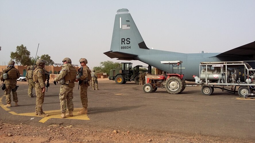 Airmen unload a C-130J Super Hercules during a deployment at Agadez, Niger, April 29, 2016.  The 435th Contingency Response Group prepared a strip a land for future-forces to establish a variety of missions. The mission and location added new challenges with 110 degrees Fahrenheit summer heat and the potential of hostile fire. (U.S. Air Force photo/ Jeffrey McGovern)