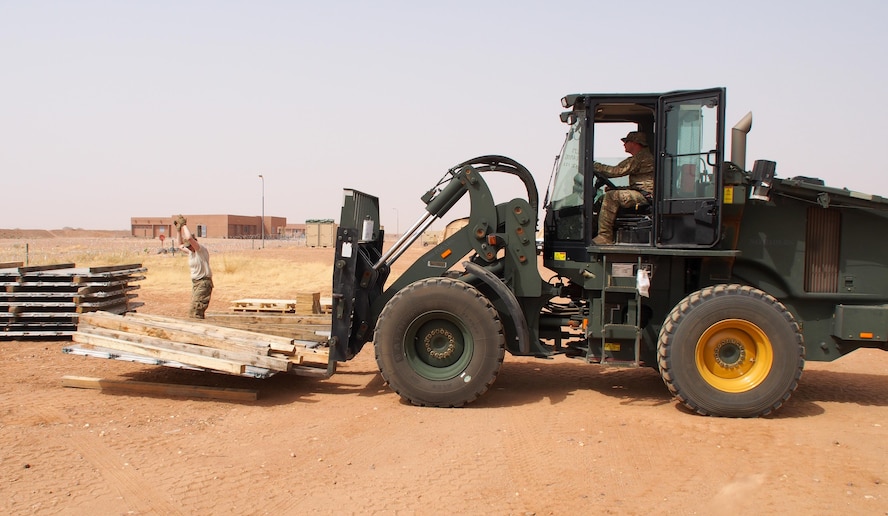 Airmen from the 435th Contingency Response Group move equipment April 28, 2016, in Africa. The 435th Contingency Response Squadron, 435th Contingency Response Support Squadron and 435th Security Forces, traveled together to build a base and prepare it for follow-on forces. The mission and location added new challenges with 110 degrees Fahrenheit summer heat and the potential of hostile fire. (U.S. Air Force photo/ Jeffrey McGovern)
