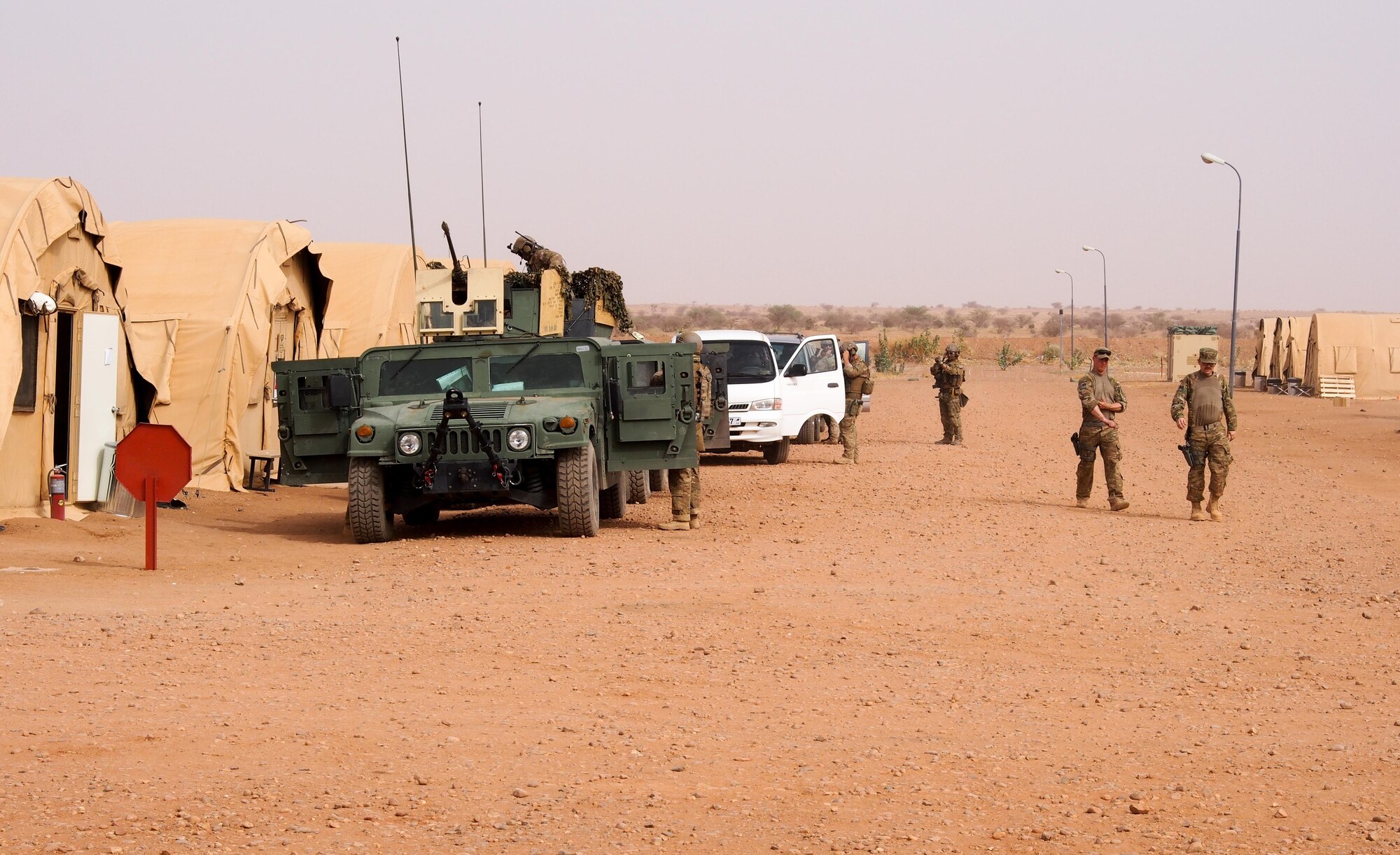 Airmen from Ramstein Air Base, Germany, prepare to convoy to an airfield near Agadez, Niger, April 29, 2016. The 435th Air Ground Operations Wing received cargo from a C-130J Super Hercules to build a base and prepare it for follow-on forces. The mission and location added new challenges with 110 degrees Fahrenheit summer heat and the potential of hostile fire.  (U.S. Air Force photo/ Jeffrey McGovern)