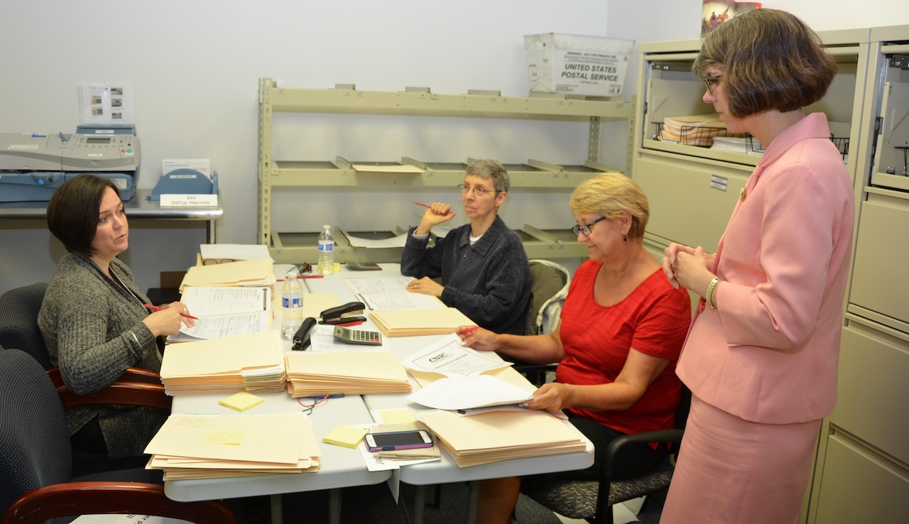 Dr. Margaret Harrell, executive director of the Office of Force Resiliency in the Office of the Undersecretary of Defense for Personnel and Readiness, right, listens to National Organization for Victim Assistance staff members describe the review process for DoD Sexual Assault Advocate Certification Program applications from military and DoD civilian sexual assault prevention and response personnel, May 19, 2016. Harrell conducted a site visit at NOVA, where the DoD Sexual Assault Advocate Certification Program Committee has helped to process more than 50,000 certification applications since 2013. DoD photo by Amaani Lyle