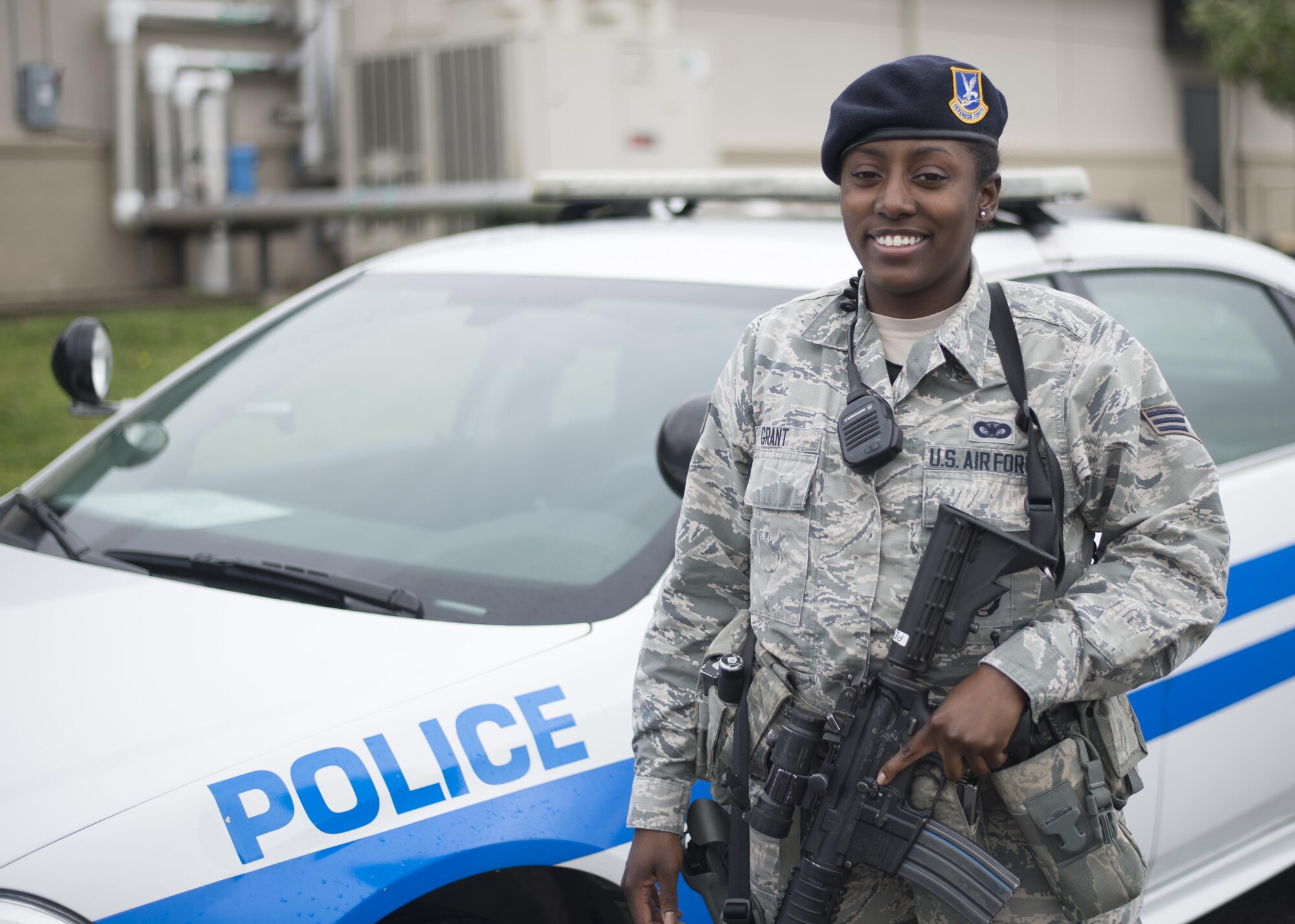 Senior Airman Janelle Grant, 512th Security Forces Squadron response force leader, poses in front of a patrol car May 13, 3016, Dover Air Force Base, Del. Grant was mobilized to augment the 436th Security Force Squadron as they required additional manning during runway renovations. (U.S. Air Force Photo/Tech Sgt. Nathan Rivard)