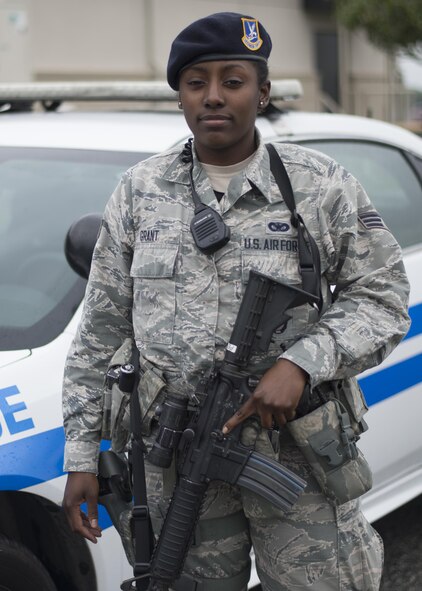 Senior Airman Janelle Grant, 512th Security Forces Squadron response force leader, poses in front of a patrol car May 13, 3016, Dover Air Force Base, Del. Grant was mobilized to augment the 436th Security Force Squadron as they required additional manning during runway renovations. (U.S. Air Force Photo/Tech Sgt. Nathan Rivard)