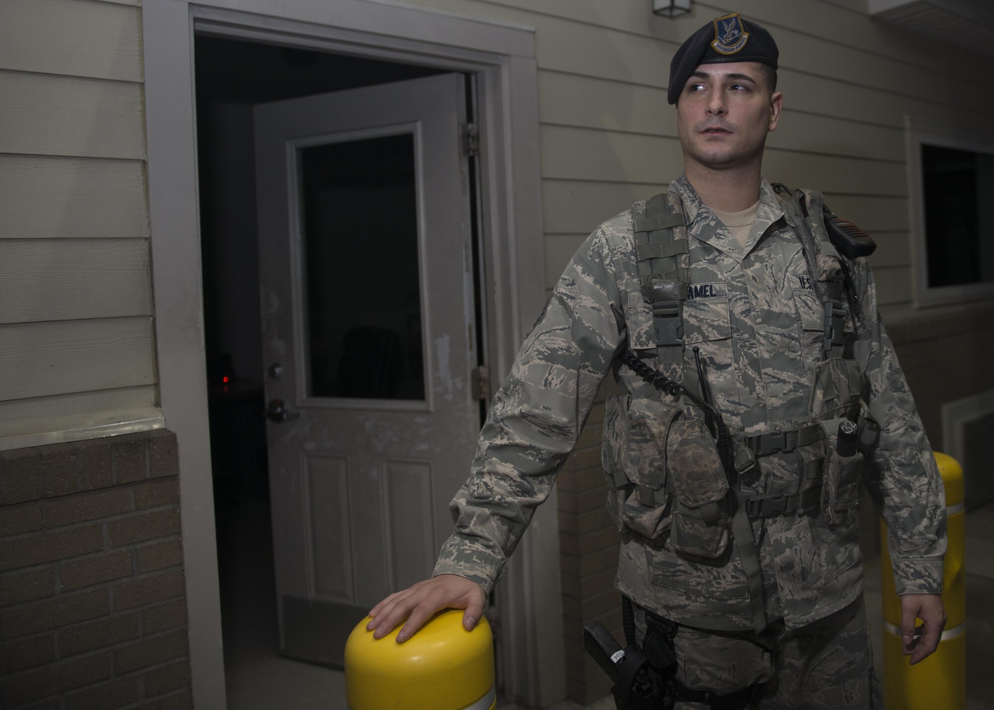 Staff Sgt. Keith Crouthamel, 512th Airlift Wing response force leader, waits for cars to approach his guard post during the night shift May 23, 2016, Dover Air Force Base, Del. Grant was mobilized to augment the 436th Security Force Squadron as they required additional manning during runway renovations. (U.S. Air Force Photo/Tech Sgt. Nathan Rivard)