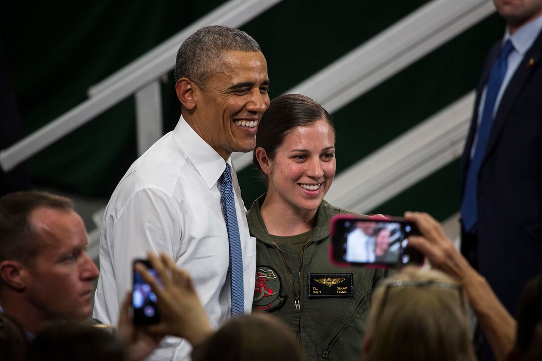 President Barack Obama poses with Capt. Tessa Snow, an Osprey pilot with Marine Medium Tiltrotor Squadron 265, during his visit to Marine Corps Air Station Iwakuni, Japan, May 27, 2016. Obama recognized Snow for her actions during the Kumamoto earthquake relief effort last month. U.S. Marine Corps photo by Cpl. Justin Fisher