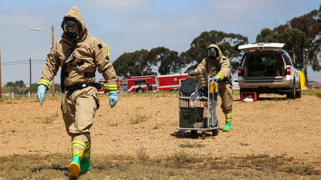 Marines with Explosive Ordnance Disposal walk toward the hazardous area during a Chemical, Biological, Radiological, Nuclear and High-Yield Explosives exercise at the gas chamber aboard Marine Corps Air Station Miramar, Calif., May 18, 2016. The exercise revolved around PMO, the Miramar Fire Department, Explosive Ordnance Disposal, and Aircraft Rescue and Firefighting working together to identify and eliminate the threat of a simulated clandestine drug lab.
