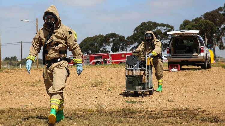 Marines with Explosive Ordnance Disposal walk toward the hazardous area during a Chemical, Biological, Radiological, Nuclear and High-Yield Explosives exercise at the gas chamber aboard Marine Corps Air Station Miramar, Calif., May 18, 2016. The exercise revolved around PMO, the Miramar Fire Department, Explosive Ordnance Disposal, and Aircraft Rescue and Firefighting working together to identify and eliminate the threat of a simulated clandestine drug lab.