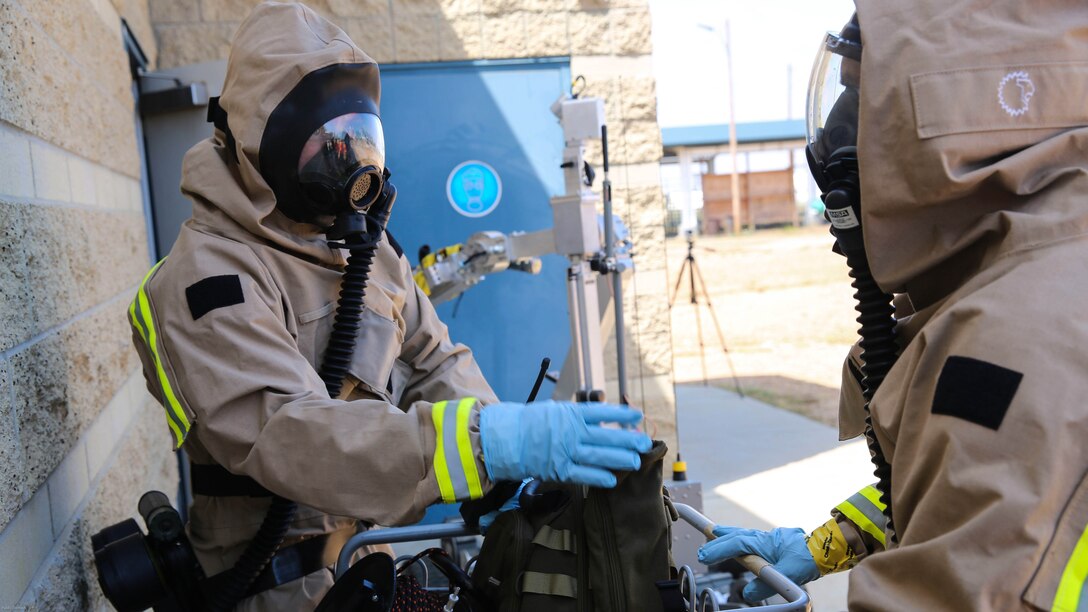 Marines with Explosive Ordnance Disposal gather their gear before entering the hazardous area during a Chemical, Biological, Radiological, Nuclear and High-Yield Explosives exercise at the gas chamber aboard Marine Corps Air Station Miramar, Calif., May 18, 2016. The exercise revolved around PMO, the Miramar Fire Department, Explosive Ordnance Disposal, and Aircraft Rescue and Firefighting working together to identify and eliminate the threat of a simulated clandestine drug lab. 