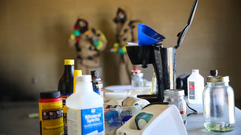Marines with the Aircraft Rescue and Firefighting hazardous material team assess the contaminated area during a Chemical, Biological, Radiological, Nuclear and High-Yield Explosives exercise at the gas chamber aboard Marine Corps Air Station Miramar, Calif., May 18, 2016. The exercise revolved around PMO, the Miramar Fire Department, Explosive Ordnance Disposal, and Aircraft Rescue and Firefighting working together to identify and eliminate the threat of a simulated clandestine drug lab. 
