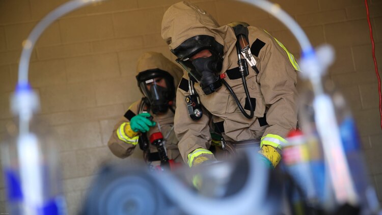 Marines with the Aircraft Rescue and Firefighting hazardous material team assess the contaminated area during a Chemical, Biological, Radiological, Nuclear and High-Yield Explosives exercise at the gas chamber aboard Marine Corps Air Station Miramar, Calif., May 18, 2016. The exercise revolved around PMO, the Miramar Fire Department, Explosive Ordnance Disposal, and Aircraft Rescue and Firefighting working together to identify and eliminate the threat of a simulated clandestine drug lab. 