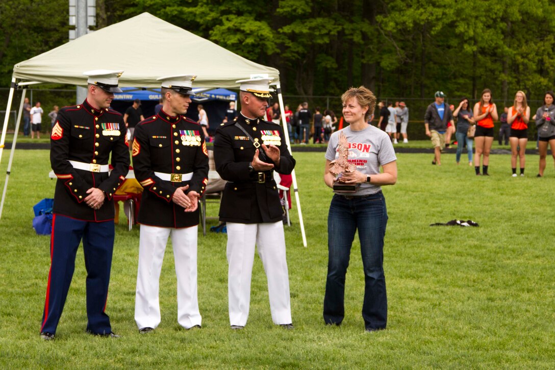 Connie Cantrell, a Mason High School math teacher and swim coach, received the Marine Corps Recruiting Station Lansing Coach of the Year Award, May 20, 2016. Each year, RS Lansing honors coaches that exemplify the Marine Corps values of honor, courage and commitment, both in the arena of competition and within their communities. Cantrell has accumulated seven league championships, only lost one head-to-head meet in the past five years, and since beginning her coaching career in 2007 has amassed more than 105 wins. Her swim team concluded the 2016 season with an undefeated regular season and another Capital Area Activities Conference (CAAC) league championship.