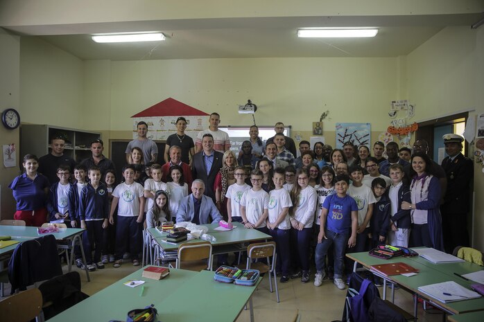 Marines and sailors with Special Purpose Marine-Air Ground Task Force Crisis Response-Africa, take a photo with Mayor Enzo Bianco, children and staff at 3rd Circolo Didattico ‘’Giovanni Paolo II’’ Gravina Di Catania, Italy, May 18, 2016.  The Marines and sailors interacted with the children, going over some English for an upcoming test, as well as creating and participating in games during the children’s recess period. (U.S. Marine Corps photo by Cpl. Alexander Mitchell/released)