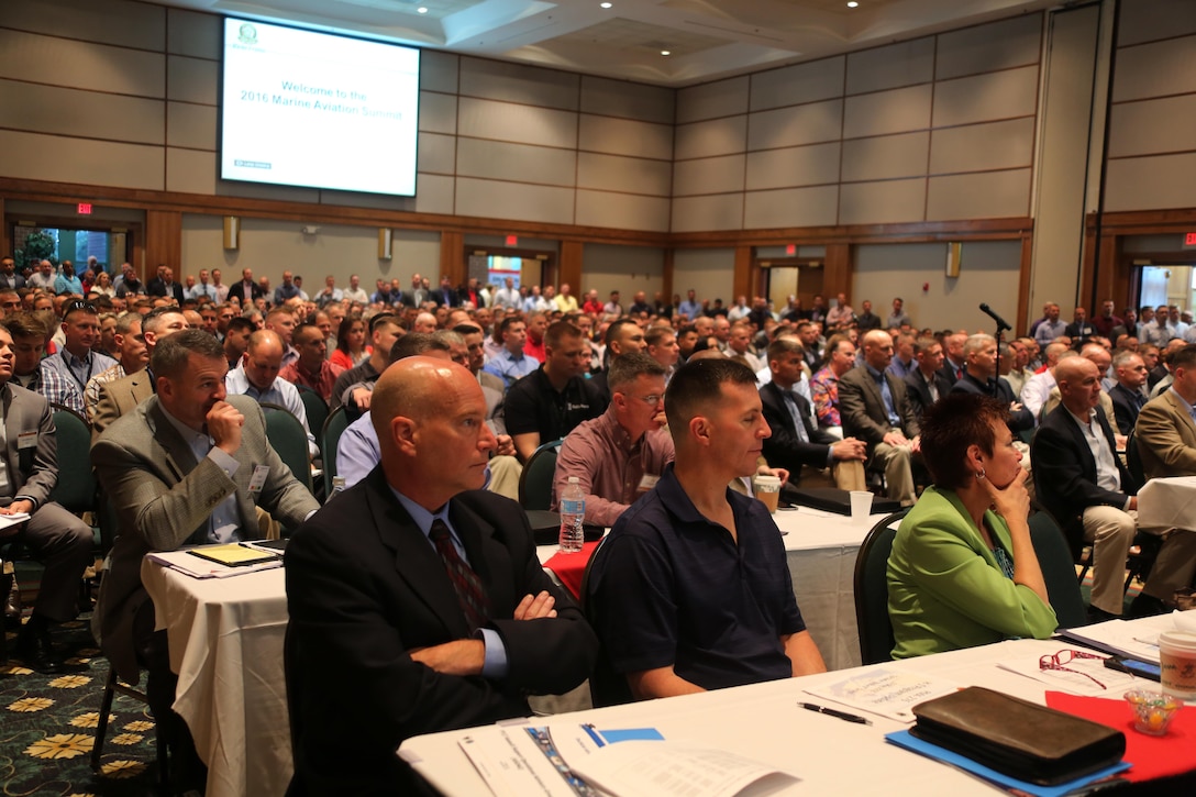 Attendees listen to opening remarks during the 45th Annual Marine Corps Aviation Association Symposium and Marine Aviation Summit at New Bern, N.C., May 17, 2016. Hundreds of naval aviators gathered at the convention center for the opening brief to the weeklong event. Senior leaders gathered to discuss the future of Marine Corps aviation and the steps the Corps is taking to reach its set goals. (U.S. Marine Corps photo by Cpl. N.W. Huertas/Released)