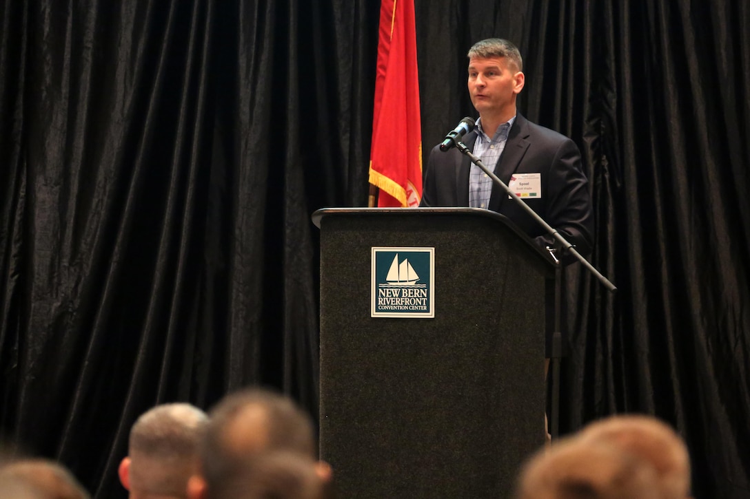 Lt. Col. Scott Wadle speaks at a brief  during the 45th Annual Marine Corps Aviation Association Symposium and Marine Aviation Summit at New Bern, N.C., May 17, 2016. Hundreds of naval aviators gathered at the convention center for the opening brief to the weeklong event. Senior leaders gathered to discuss the future of Marine Corps aviation and the steps the Corps is taking to reach its set goals. Wadle is a section leader with the aviation department with Headquarters Marine Corps. (U.S. Marine Corps photo by Cpl. N.W. Huertas/Released)