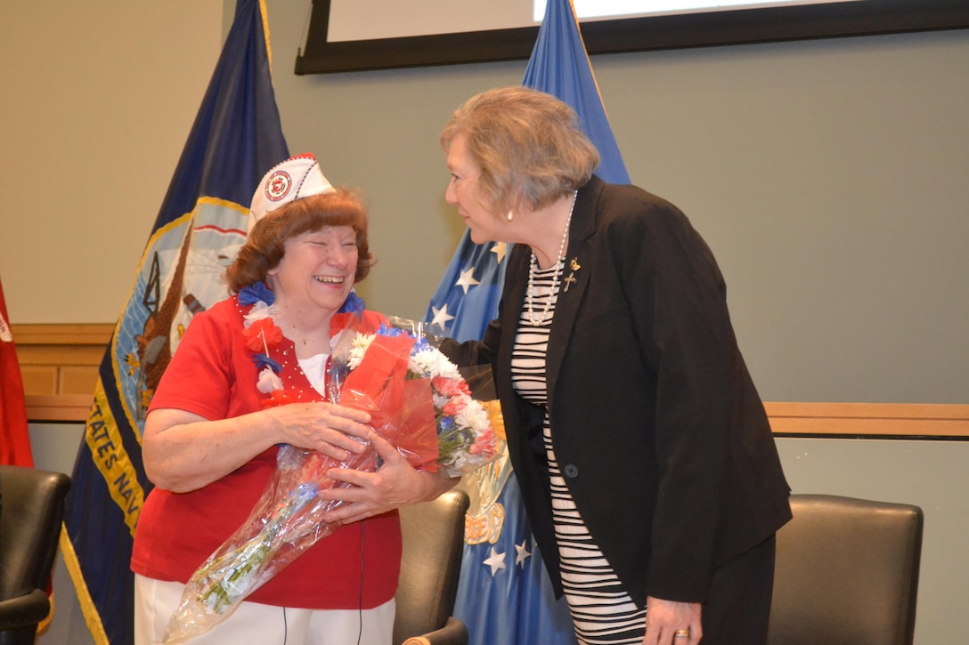 Winifred Woll, keynote speaker during the Memorial Day observation May 26, receives a thank you bouquet from Jackie Baxter, Philadelphia Compound Veterans Committee chairperson. The PCVC organized the ceremony.